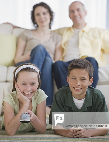 Family with two children watching television