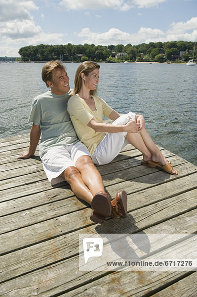 Couple sitting on dock