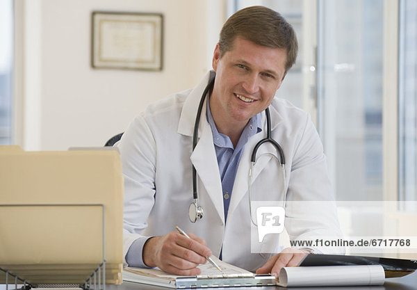 Male doctor posing at desk