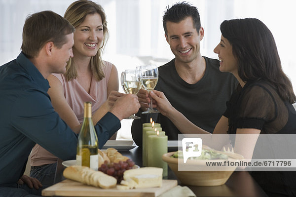 Couples toasting with wine glasses