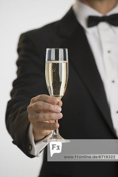 Man in tuxedo toasting with champagne