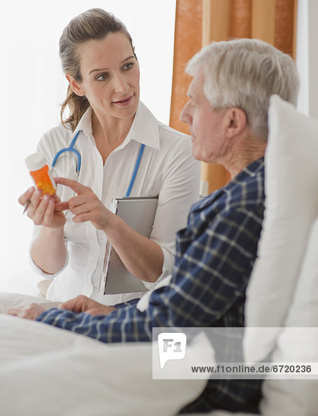 Nurse explaining prescription to senior man