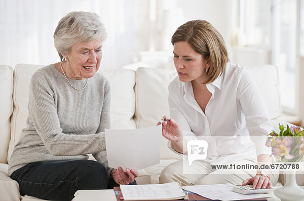 Mature woman giving financial advice to senior woman