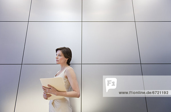 Mature businesswoman holding document  low angle view