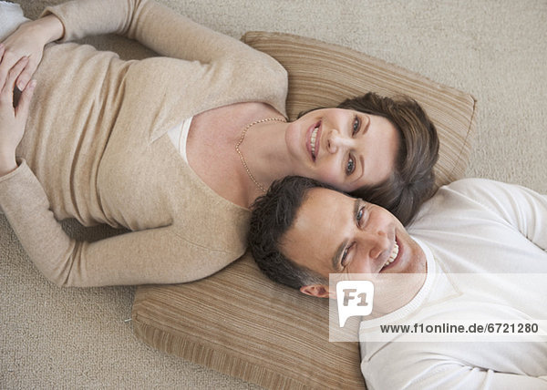 Portrait of couple lying on floor