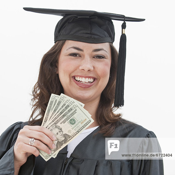 A graduate holding money