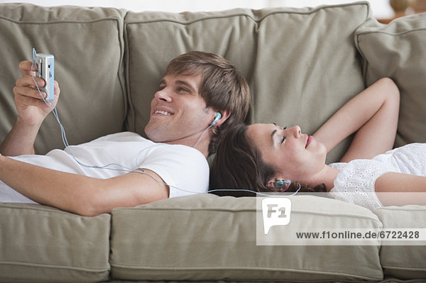 Couple in living room listening to music