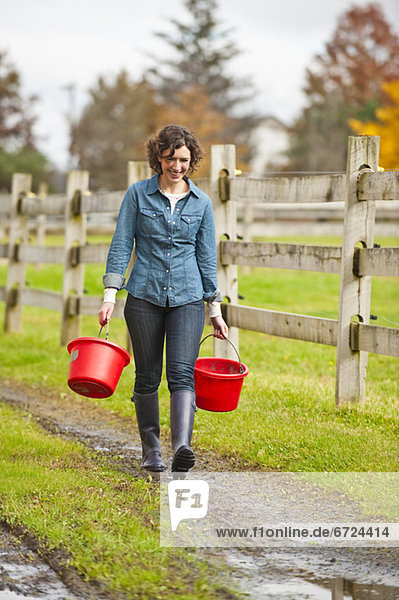 Woman carrying buckets