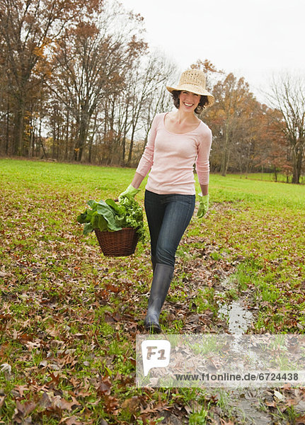 Woman walking with basket of vegetables