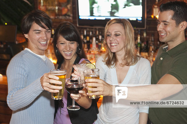 Friends toasting at bar