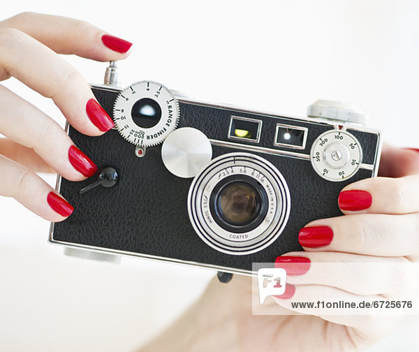 Woman holding antique camera