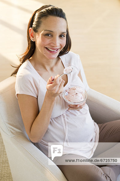 Pregnant woman eating a bowl of ice cream