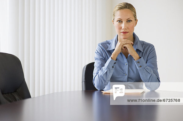 Businesswoman sitting at conference table