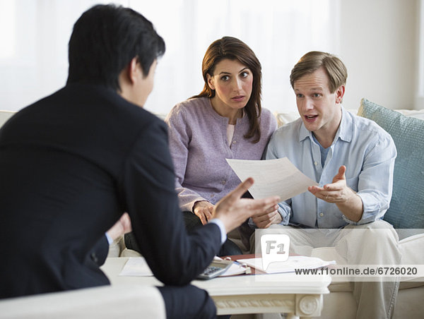 Financial planner talking to couple in their home