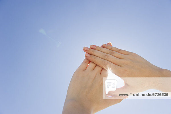 Four hands holding wrists of other people - Stock Photo - Dissolve