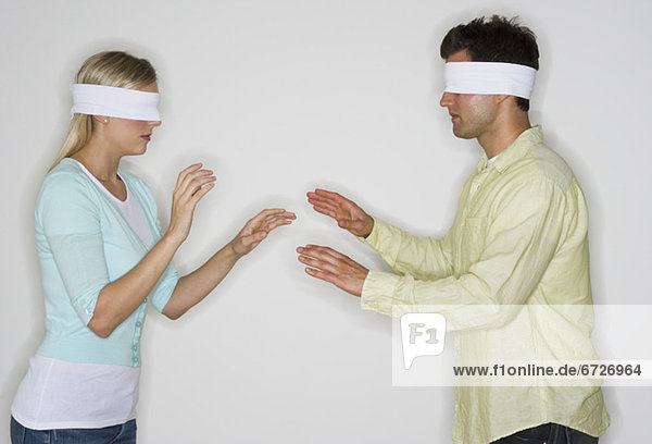 Blindfolded couple looking for each other