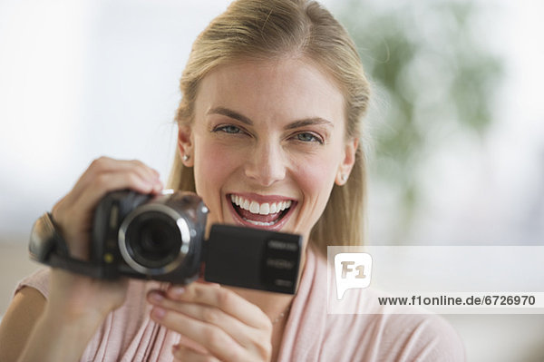Woman laughing while taking a video