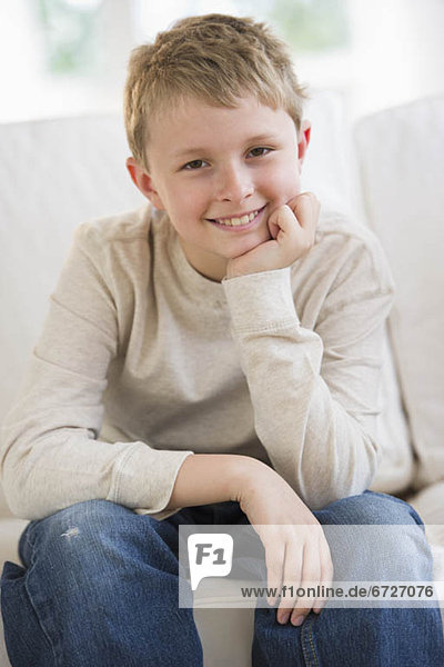 Young boy sitting on couch