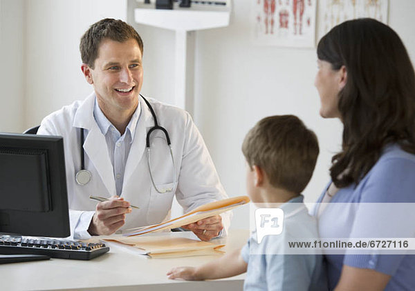 Doctor talking to woman and her son