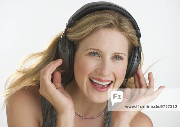 Blond woman listening to music with headphones