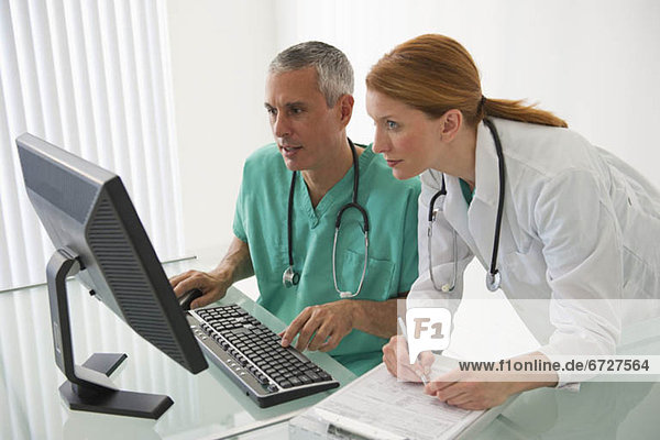 Healthcare professionals looking at computer