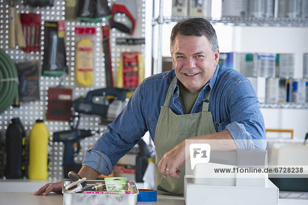 USA  New Jersey  Jersey City  Portrait of hardware shop owner at counter