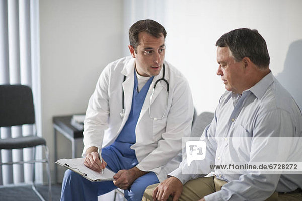 USA  New Jersey  Jersey City  Doctor discussing medical results with male patient in hospital