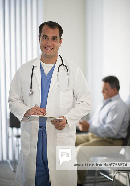 USA  New Jersey  Jersey City  Portrait of doctor holding medical results with male patient in background