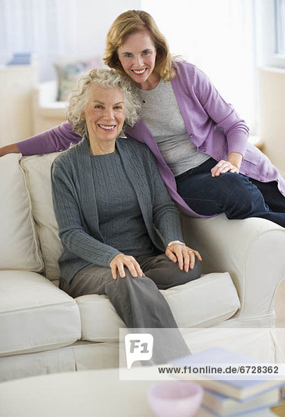 USA  New Jersey  Jersey City  Portrait of mother and daughter smiling on sofa