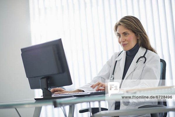 USA  New Jersey  Jersey City  Female doctor using computer in office