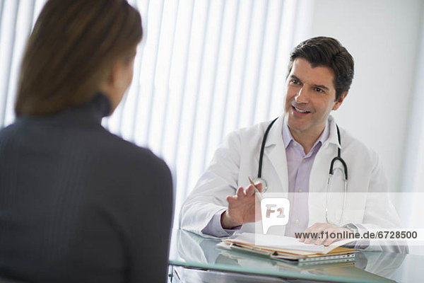 USA  New Jersey  Jersey City  Doctor talking with female patient in office
