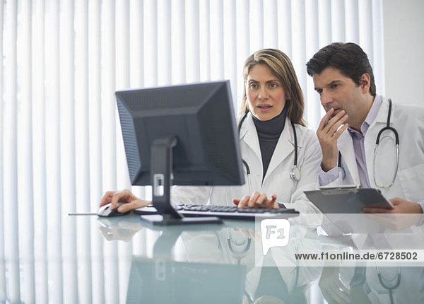 USA  New Jersey  Jersey City  Two doctors using computer in office