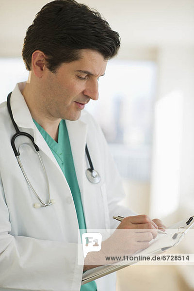 USA  New Jersey  Jersey City  Male doctor writing medical report