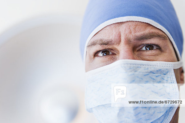 Male surgeon wearing surgical mask