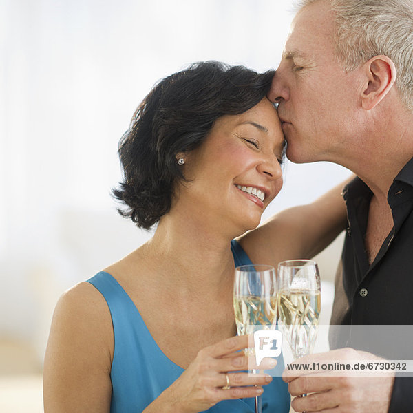 Happy mature couple with flutes