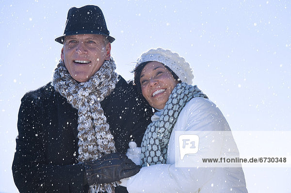 Happy mature couple in winter scenery