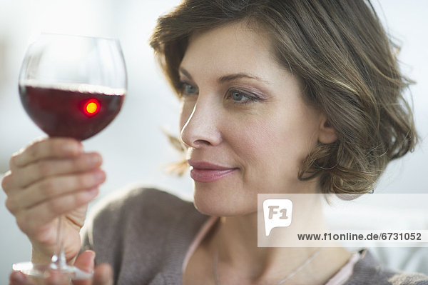 USA  New Jersey  Jersey City  portrait of woman holding glass of red wine