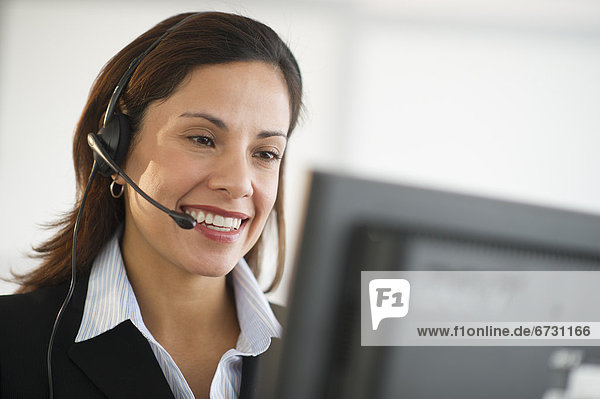 USA  New Jersey  Jersey City  smiling female customer service representative with headset