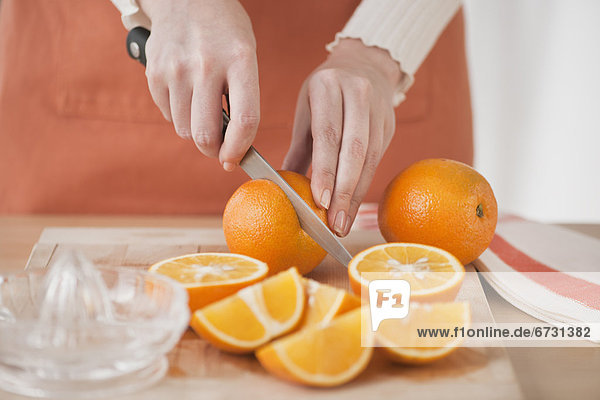 Woman cutting oranges