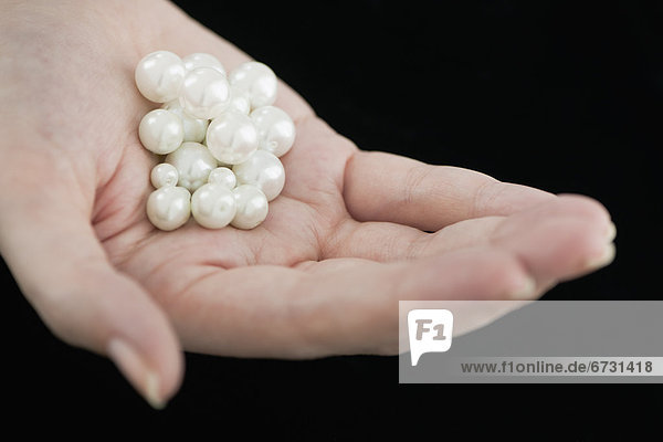 Woman holding pearls