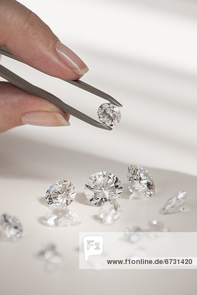 Studio shot of woman holding diamonds