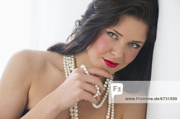 Portrait of young woman wearing pearls