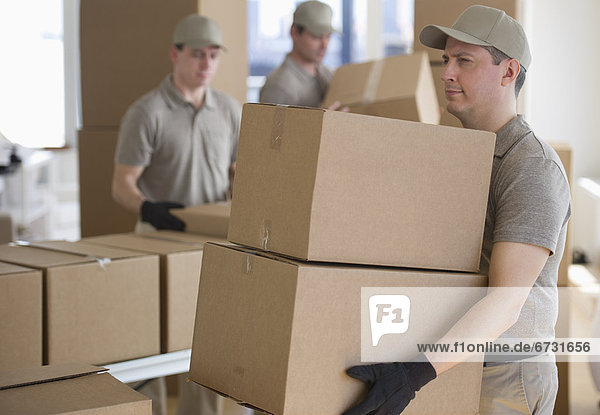 USA  New Jersey  Jersey City  men sorting boxes in warehouse