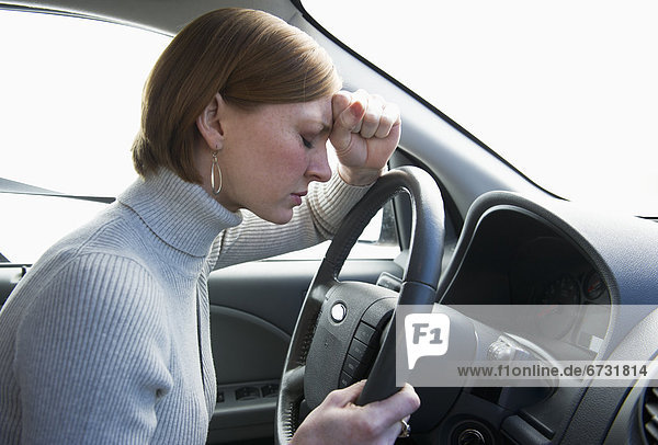 USA  New Jersey  Jersey City  woman driving car looking upset