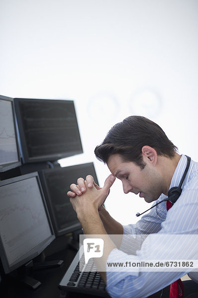 Upset financial worker analyzing data displayed on computer screen