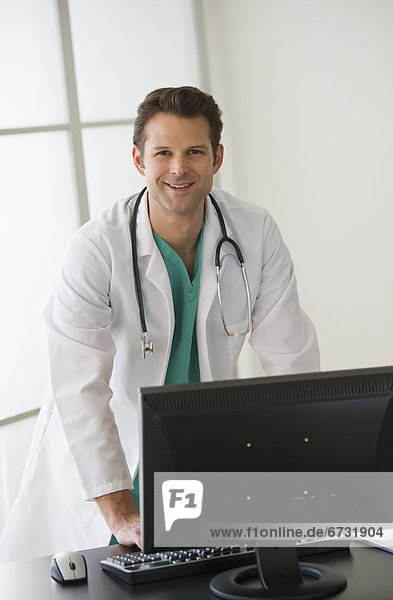 Portrait of doctor working on computer