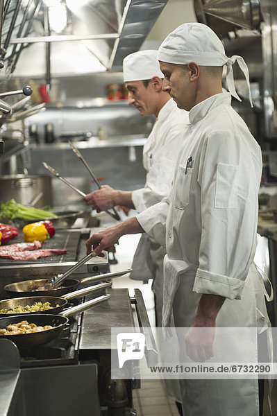 Chefs preparing food in kitchen