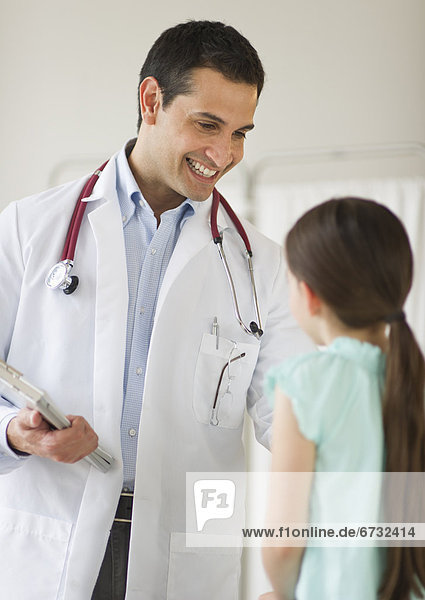Doctor talking to girl (8-9)