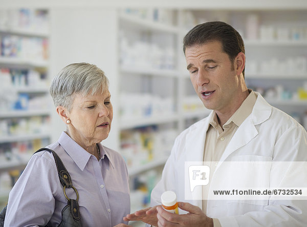 Senior woman talking to pharmacist