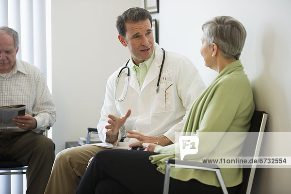 Senior couple talking to doctor